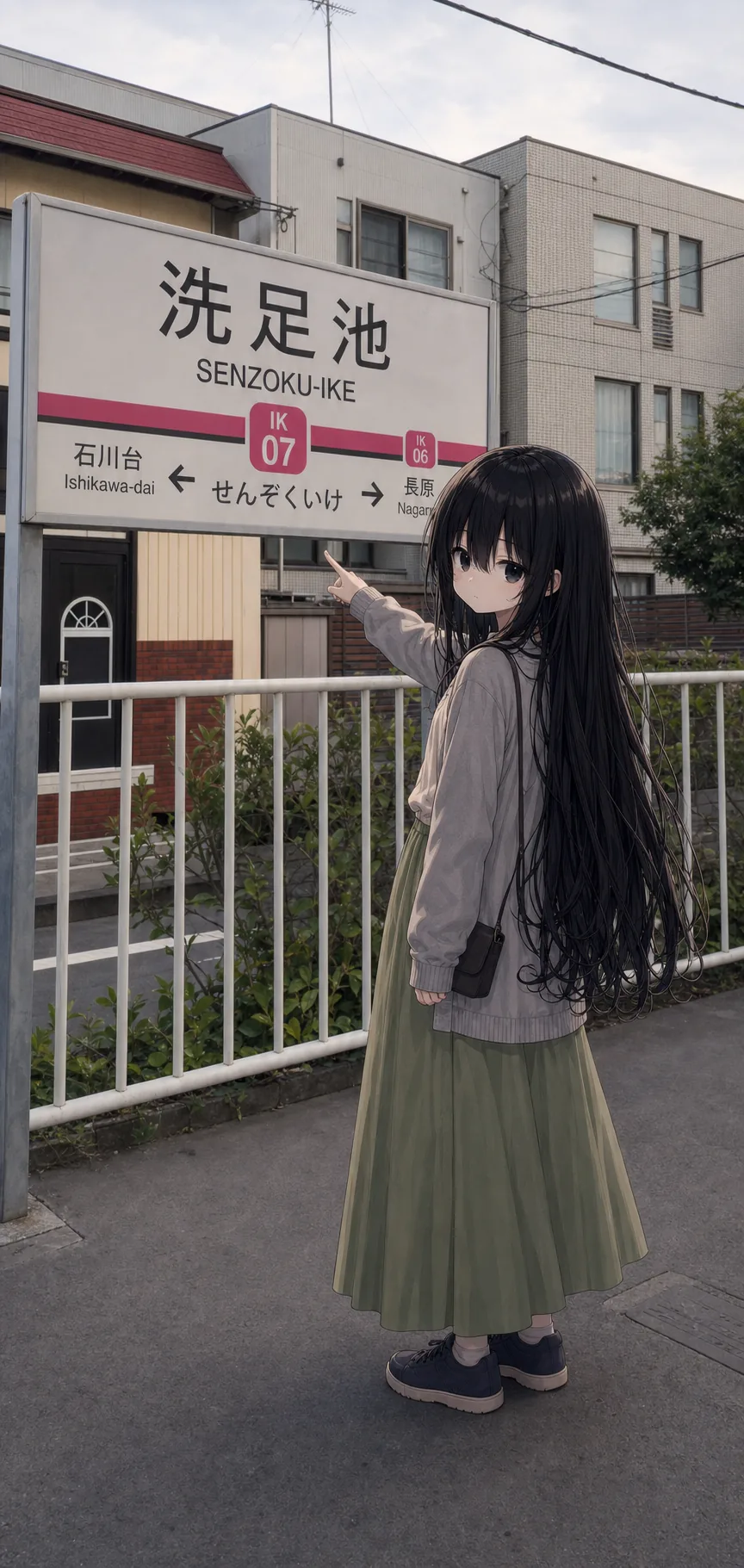 洗足池駅の駅名標の前で